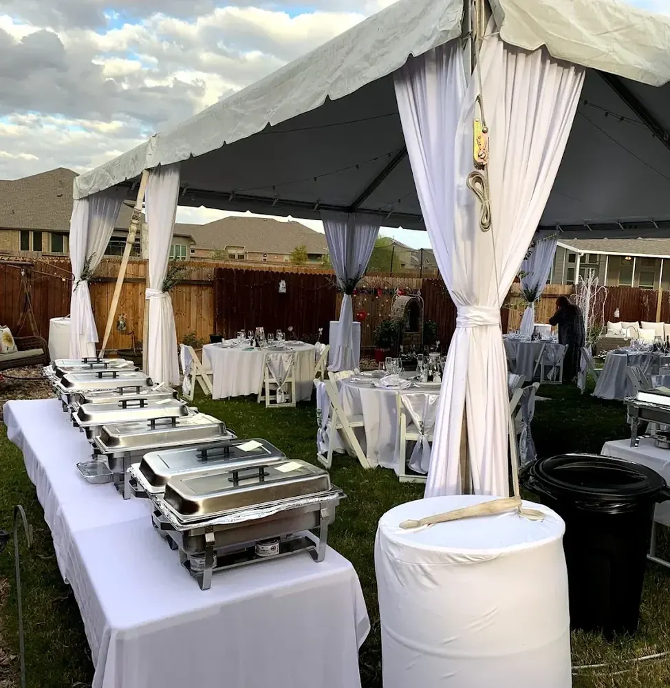 Rock N Grill catering setup — chafing dishes under a marquee at an outdoor event